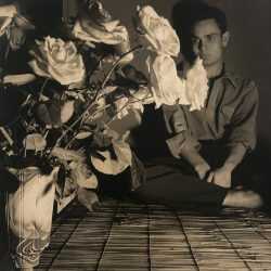 Photograph by George Platt Lynes: [Chuck Howard Looking at Roses], available at Childs Gallery, Boston