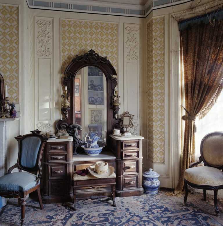 Photograph by Thurber Shellburne: 9 Wellington Street: Ralph’s bedroom – Dresser with Alien doll and blue upholstered chair, available at Childs Gallery, Boston